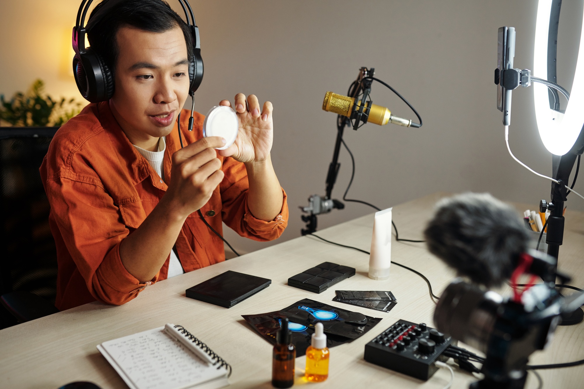 Asian Man Advertising Cosmetic Products