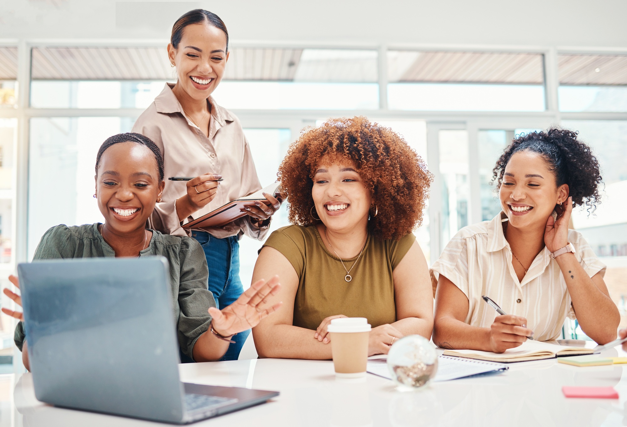 Business women, computer and team planning, collaboration and happy presentation in marketing meeting to learn about schema markup.