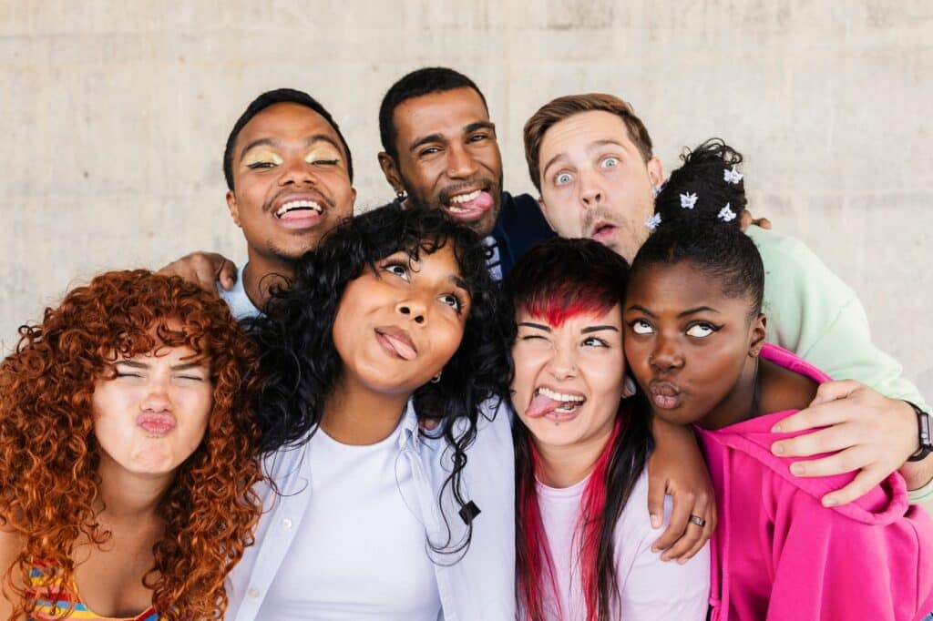 Group of diverse friends making funny faces together
