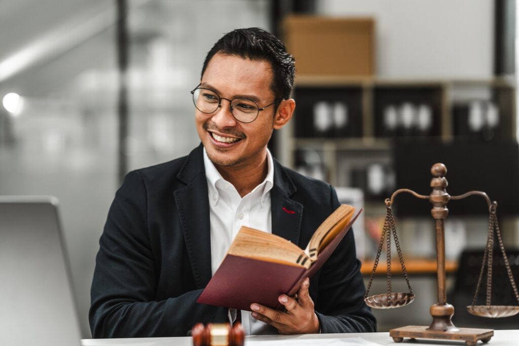 Handsome businessman lawyer of Indian descent at a law firm. trusted litigation lawyers attorneys.
