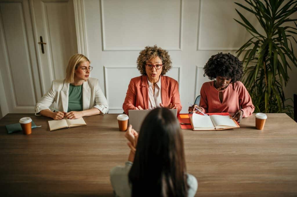 Job applicant having interview with hiring managers