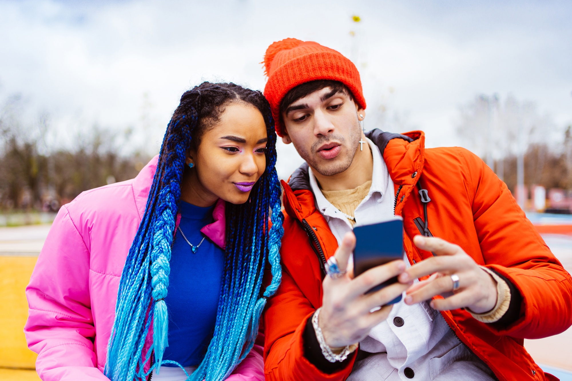 Multiracial young couple of lovers dating outdoors in winter